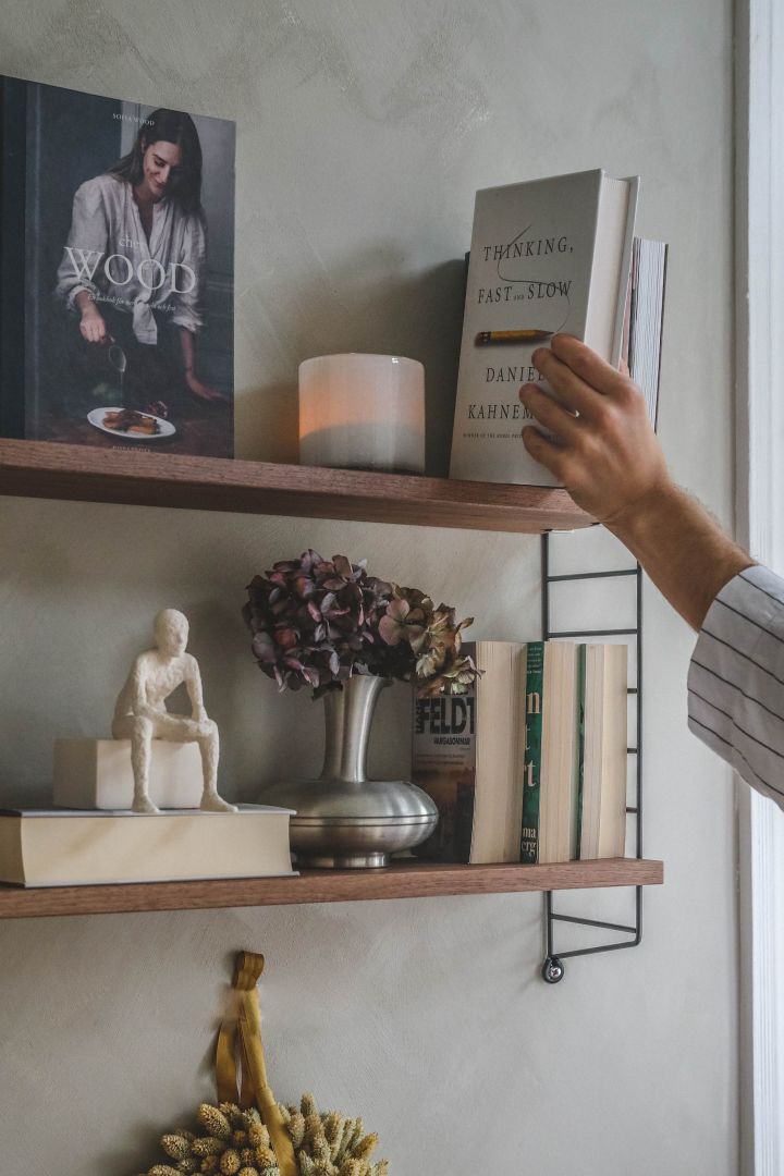 Decorate a small home office space with the String Pocket shelf system seen here at the home of Swedish influencer Hannes Mauritzson. 