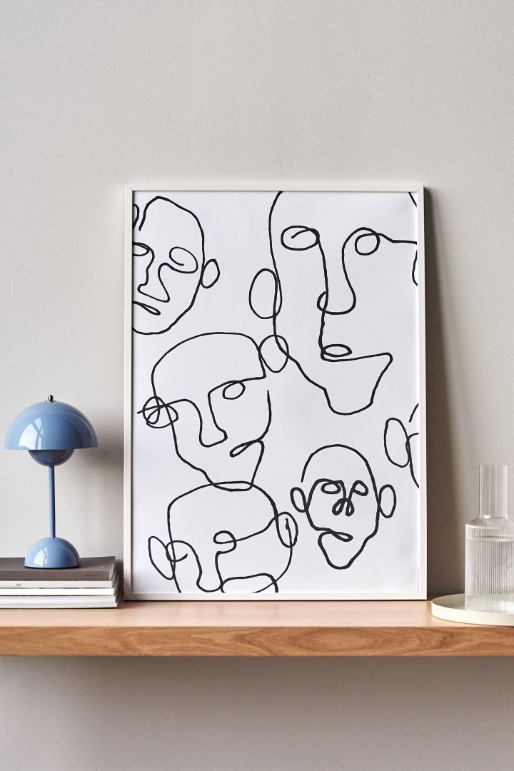 17 stylish Scandinavian wall posters to give your walls an update - here you see the graphic Audience poster from Paper Collective in tones of black and white that represent several graphic faces.