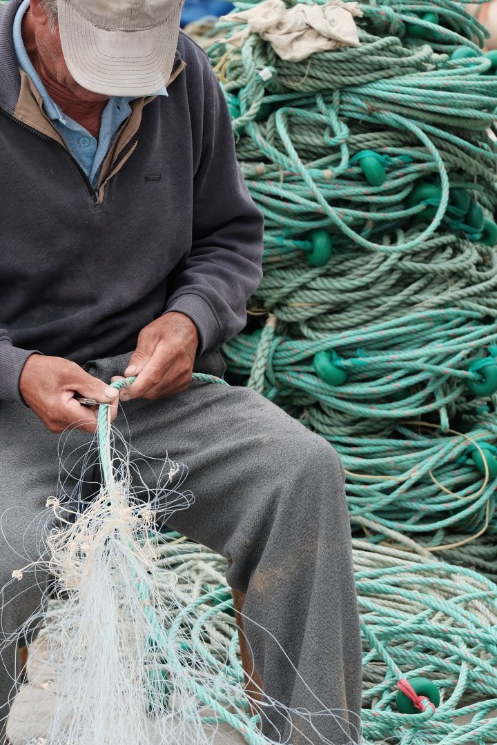 Here you see a man cleaning fishing nets in Portugal, part of the sustainable furniture initiative from Ekbacken studios where the nets will be turned into 3D printed furniture. 