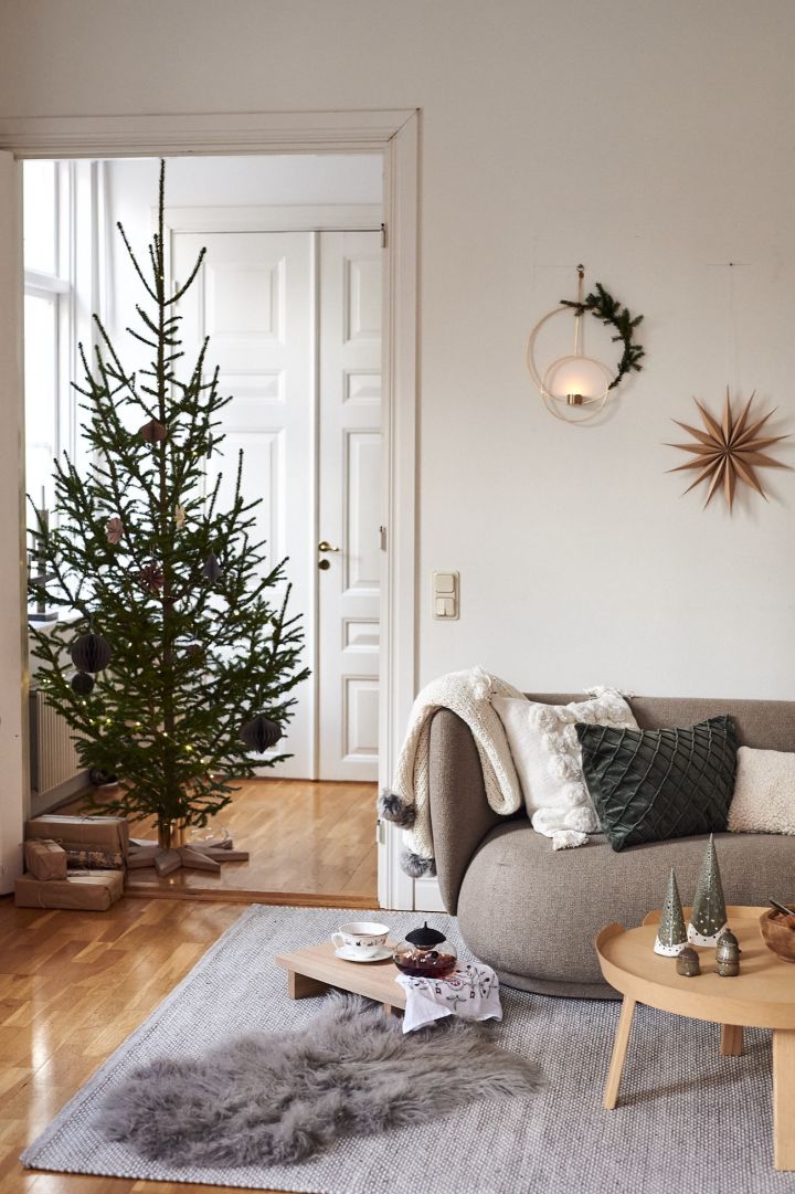 A living room decorated in white and green shows how Christmas decor can be stylish and minimalist.