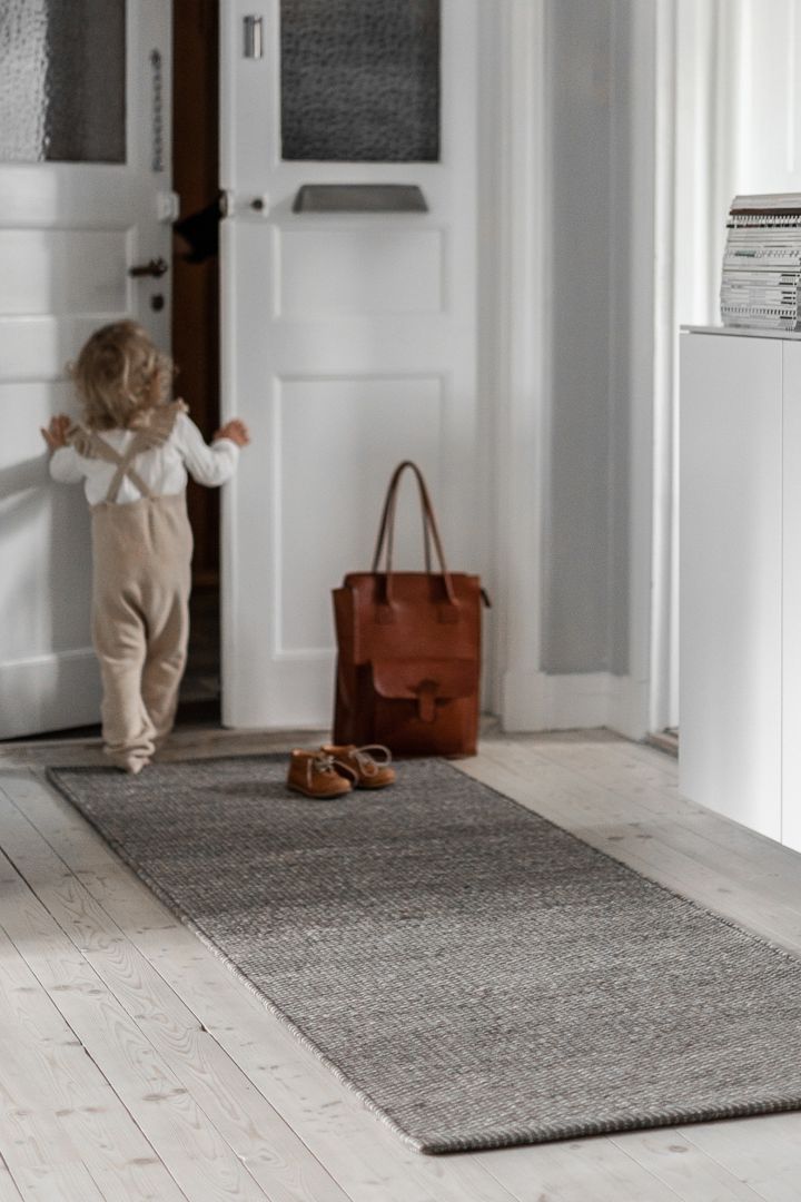 How to decorate a small hallway - take inspiration from a long narrow cosy rug from Scandi Living that creates space and a cosy feel.