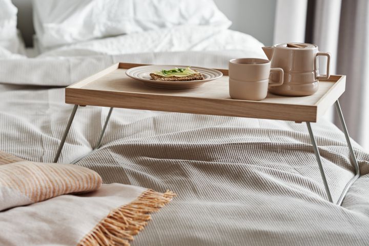 Tactile beige porcelain from NJRD makes the perfect accompaniment to breakfast in bed along with a soft recycled cotton throw. 