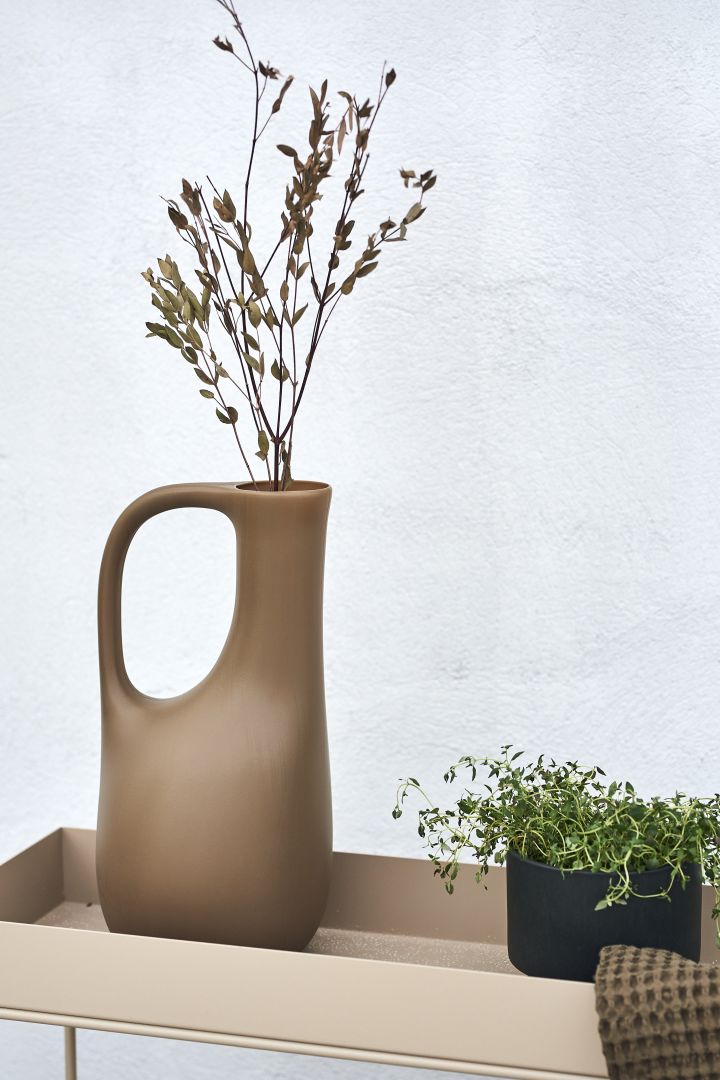 Cosy patio decor ideas - Create a cosy patio by decorating it with plants and greenery. Fill ferm LIVING's watering can with fine twigs and it can be used as a vase instead.