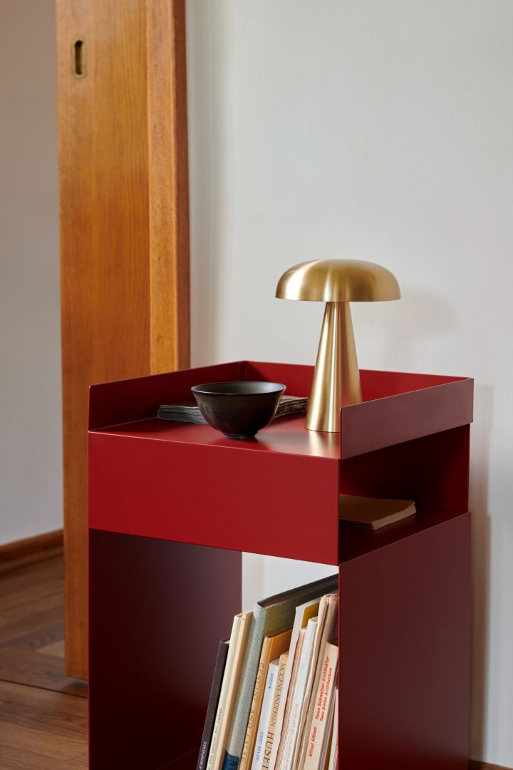 The red Rotate side table and the Como portable table lamp both from &Tradition . 
