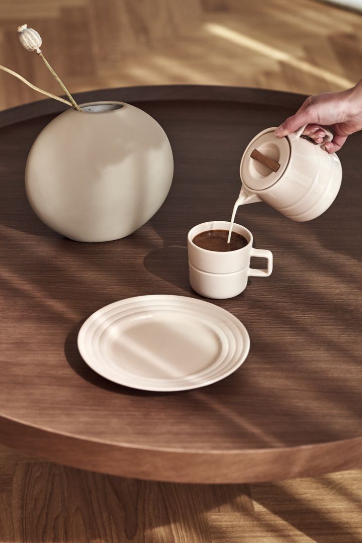 Milk pours from the NJRD Line's milk jug into the Line's coffee mug from also NJRD, both in a gorgeous shade of beige - two of all 7 beige favorites to invest in this autumn.