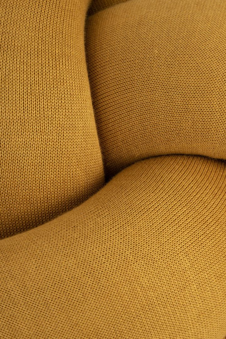 Extreme close up of the Knot Cushion in yellow.